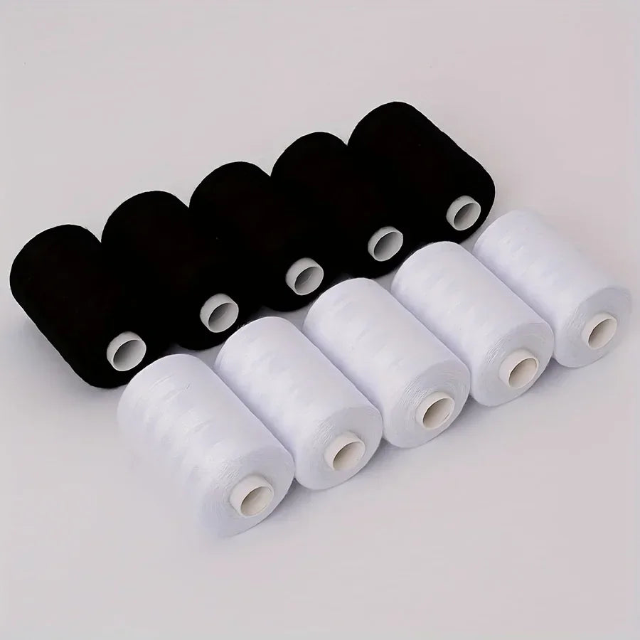 A collection of ten rolls of black and white polyester sewing thread for crafting.