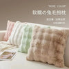 A collection of fluffy, textured throw pillow covers in various pastel shades displayed on a white surface.