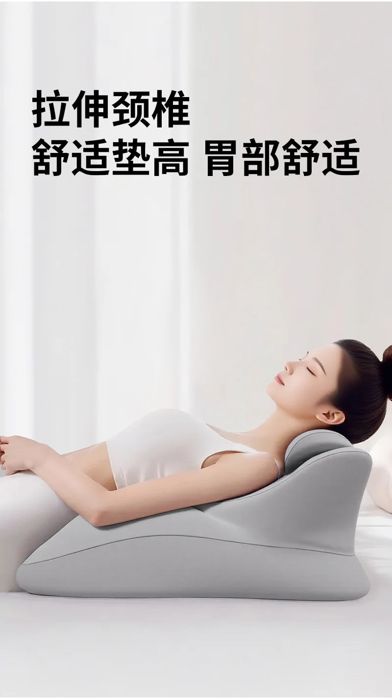 A person is lying down using a gray ergonomic memory foam wedge pillow for massage or support.