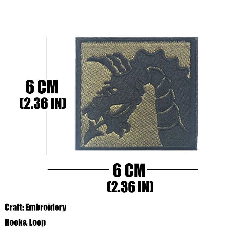 A dark gray embroidered tactical patch featuring a stylized dragon head on a tan background.
