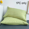 One piece of light green cotton brushed pillowcase with envelope closure shown on a gray surface.
