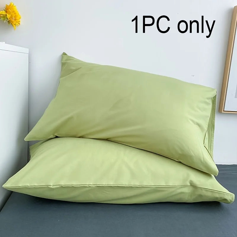 One piece of light green cotton brushed pillowcase with envelope closure shown on a gray surface.