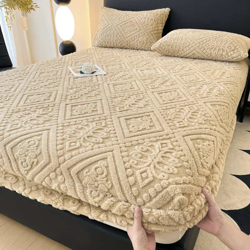 A beige plush jacquard mattress cover is shown on a bed, featuring an intricate geometric pattern.
