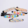 A set of colorful, patterned head supports for a baby car seat.