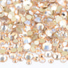 A close-up view of a mix of clear and gold glass rhinestones for DIY crafts.