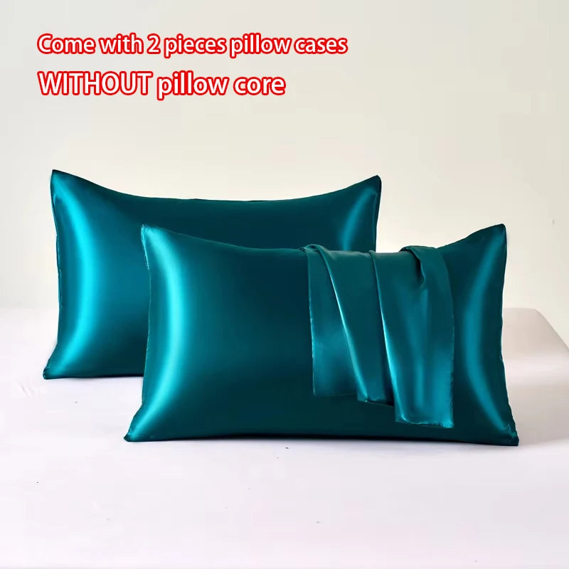 Two teal satin pillow cases without a pillow core displayed on a white surface.
