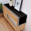 A wooden cabinet with a black placemat and table runner featuring a geometric pattern.
