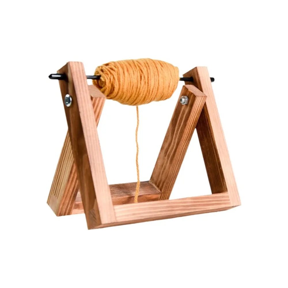 A wooden rotating yarn storage rack holding a ball of golden yellow yarn.