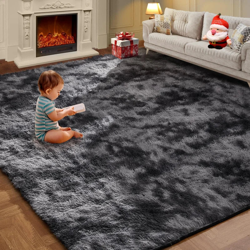 A fluffy gray living room rug with a white border is placed on a wooden floor next to a sofa and fireplace.