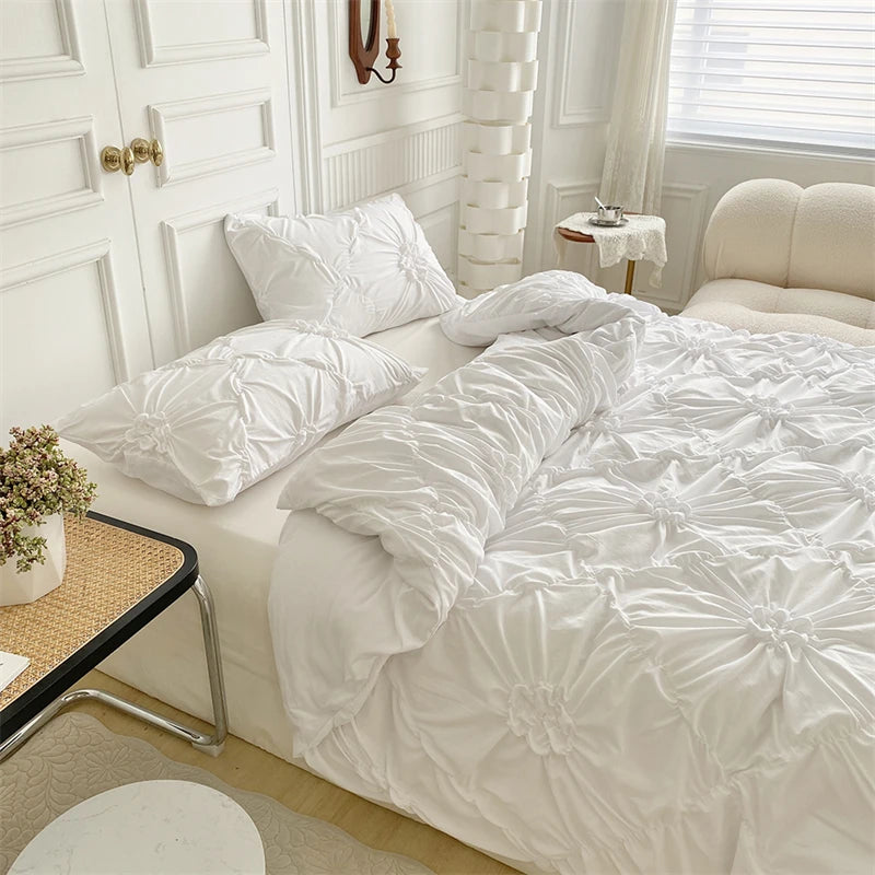 A white duvet cover set with a floral pattern is displayed on a bed in a bright, light-filled room.