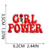 Red embroidered patch with the text GIRL POWER on a white background.
