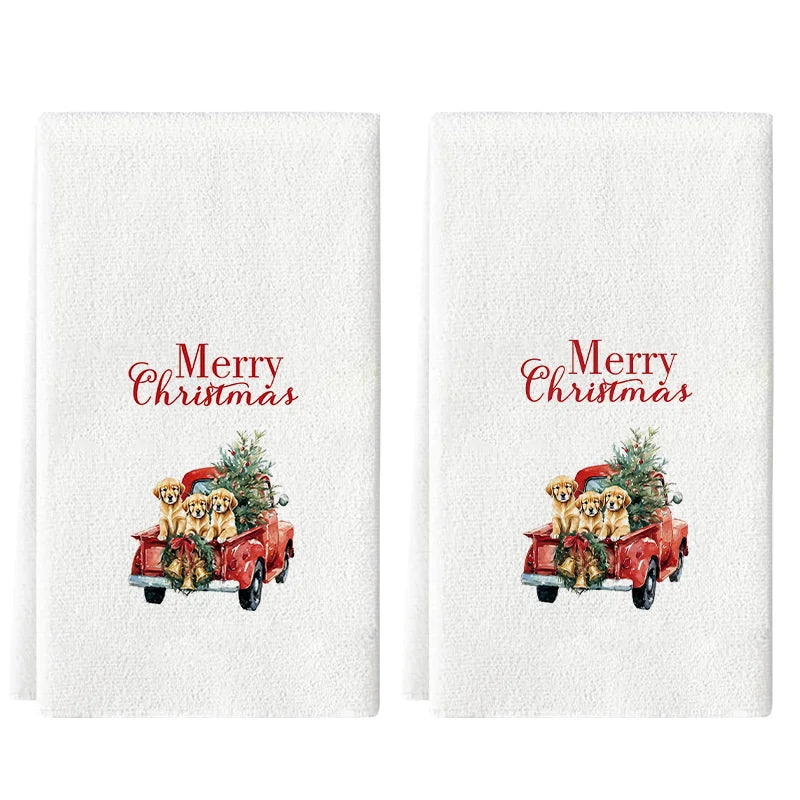 A set of white kitchen towels featuring a festive Christmas design with a red truck carrying golden dogs and greenery.