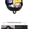 Black durable student backpack showing interior organization with various items like a passport and magazine.