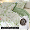 A white leaf floral duvet cover set is displayed next to a white washing machine.