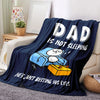 A dark blue blanket featuring a cartoon of a dad not sleeping and the text Dad is not sleeping.