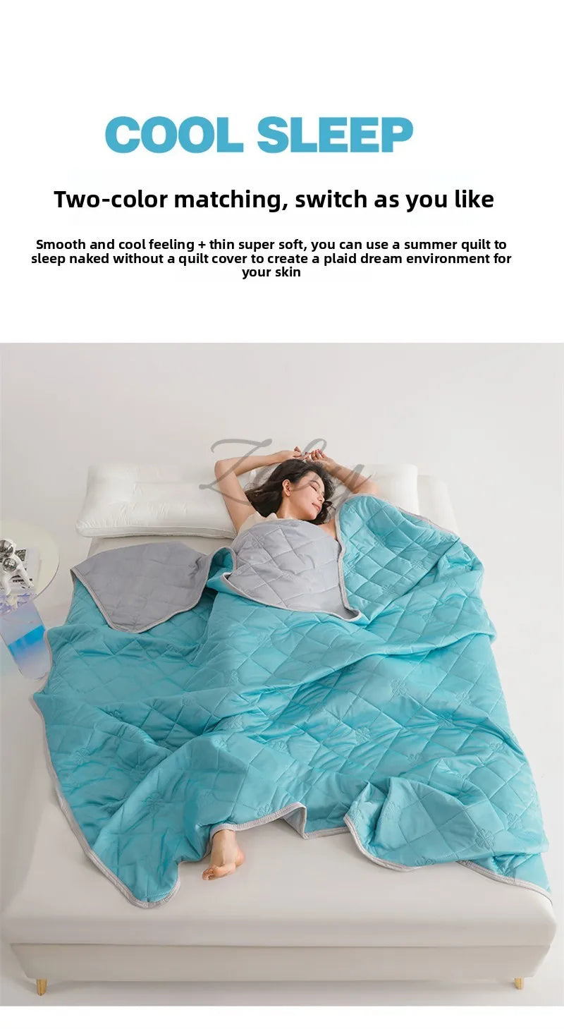 A person is lying on a bed covered with a bright blue quilted blanket, demonstrating the two-color matching feature.