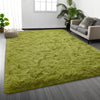 A bright lime green shaggy rug placed on a gray wooden floor in a modern living room setting.