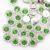 A close-up of sunflower crystal rhinestone sew-on buttons in silver and green shades.