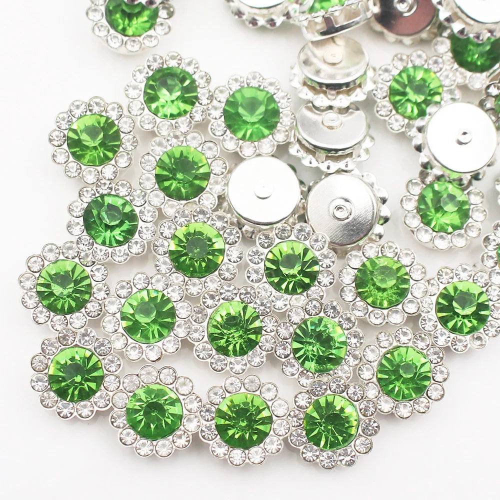 A close-up of sunflower crystal rhinestone sew-on buttons in silver and green shades.