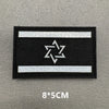 A black rectangular patch with a white border and a white six-pointed star design.