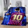 A blue and red soccer jersey blanket featuring Lionel Messi's number 10 draped over a white sofa.