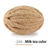 A ball of extra thick hand-knitted yarn in a milk tea color.