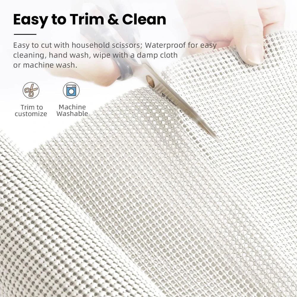 A hand is using a silicone non-slip drawer liner to trim and clean a fabric surface.