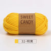 A skein of bright yellow sweet candy yarn is displayed next to a label indicating the color 32-明黃.