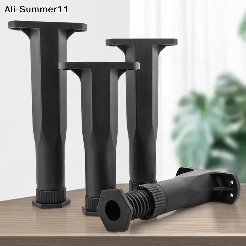 Three black heavy-duty adjustable furniture support legs standing upright on a wooden surface.