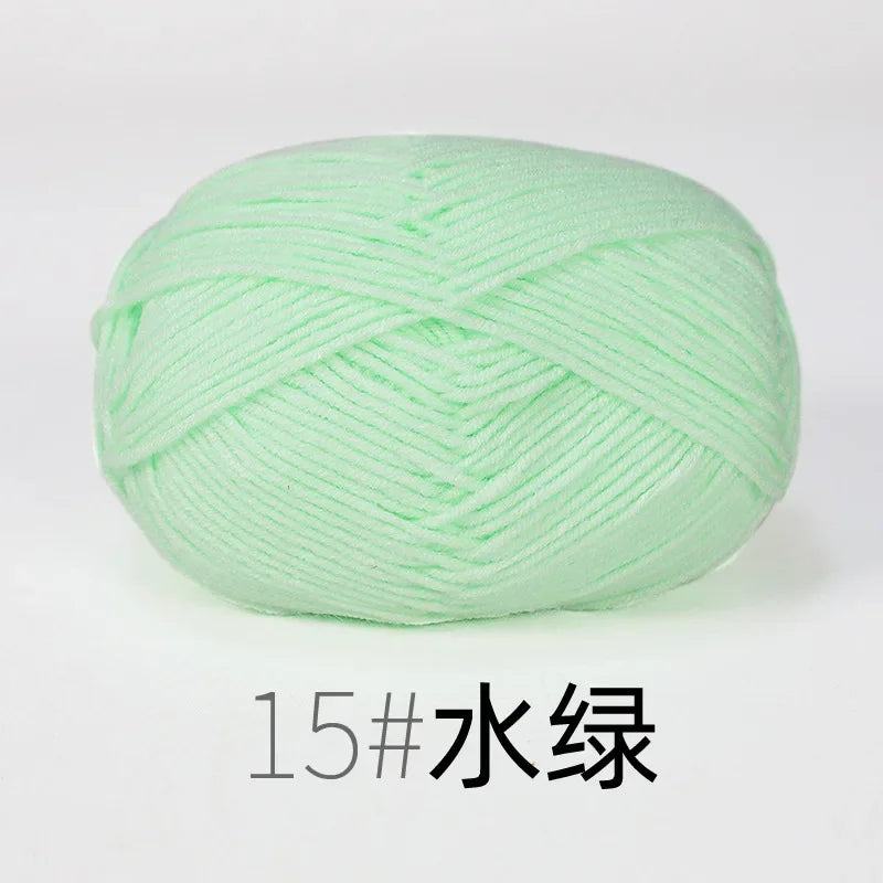 A ball of light green organic cotton 4ply knitting yarn.