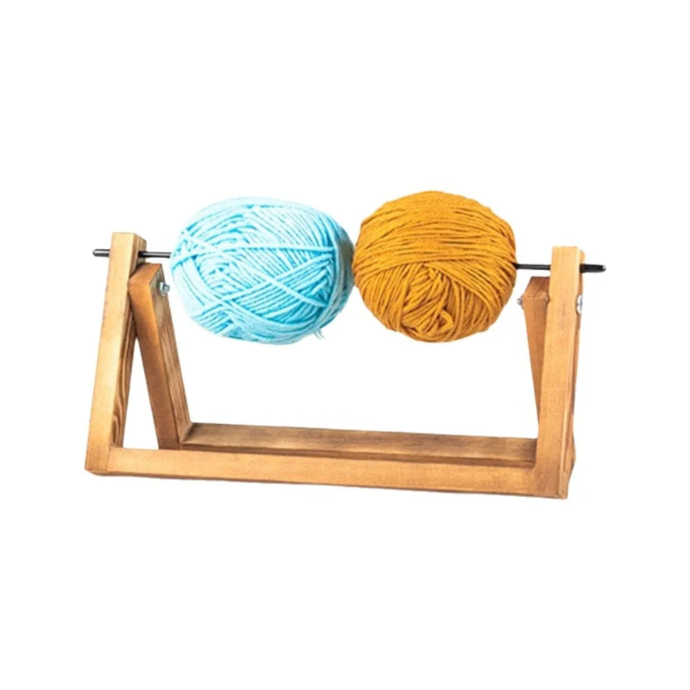 Handmade rotating yarn storage rack holding two balls of yarn, one blue and one orange.