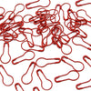 A pile of red safety bulb pins for knitting and sewing used for crafting projects.