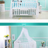 White foldable mosquito net canopy over a baby cot with a white wooden frame.