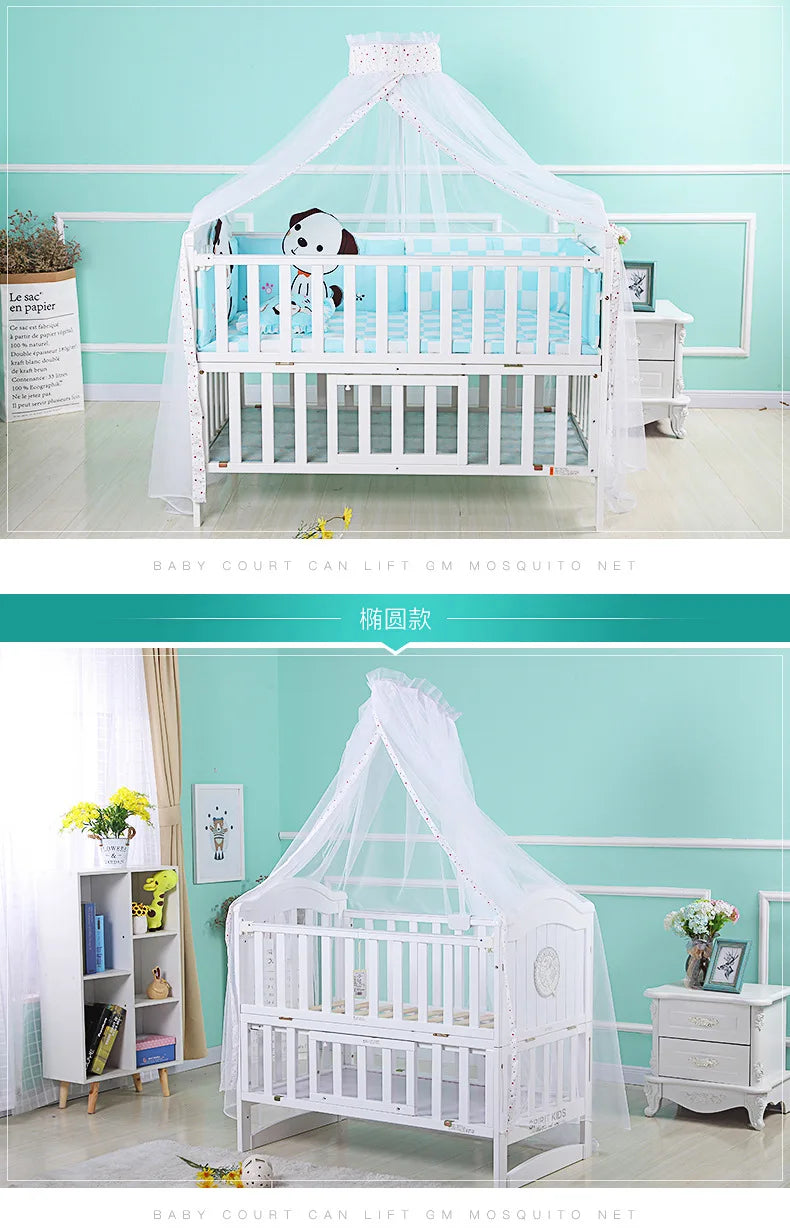 White foldable mosquito net canopy over a baby cot with a white wooden frame.