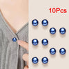 Ten blue pearl button pins arranged on a beige background.