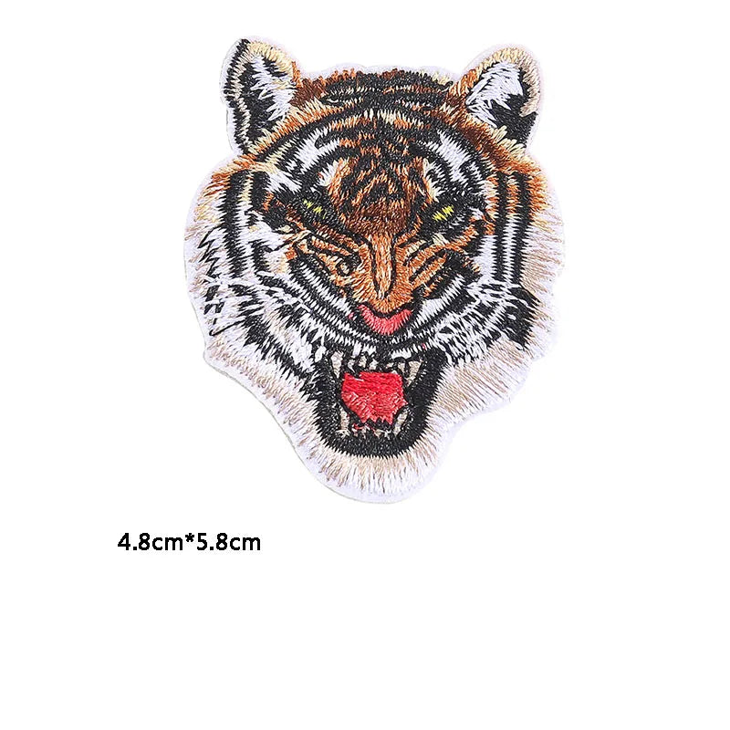 Embroidery patch of a tiger head featuring black, orange, and white fur details.