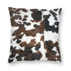 A square cushion cover featuring a brown and white cowhide print.