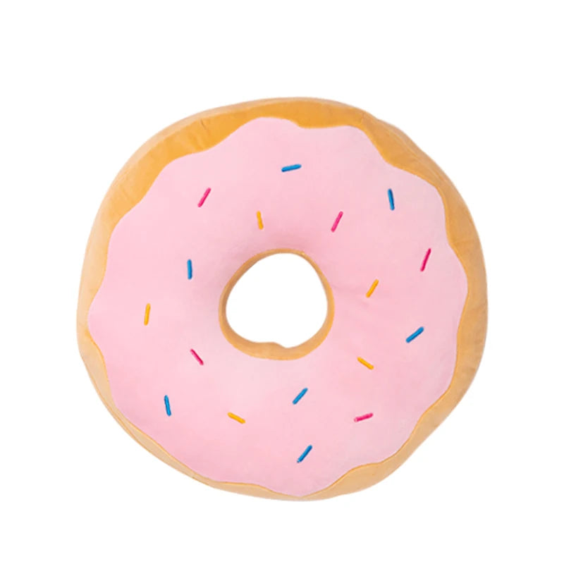 A pink frosted doughnut with colorful sprinkles, designed as a soft cuddle cushion.