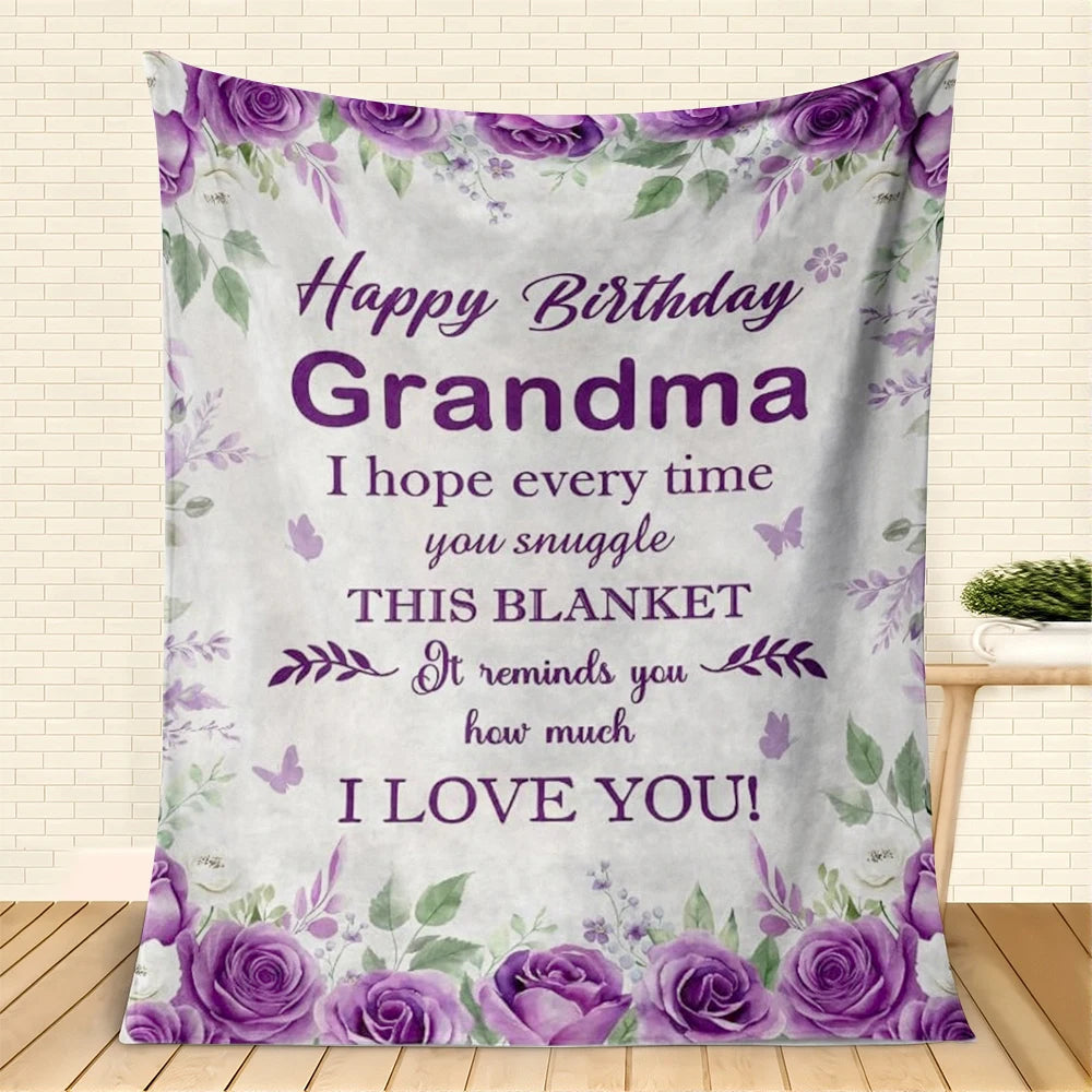 A purple floral blanket featuring a 'Happy Birthday Grandma' message and roses on a white background.