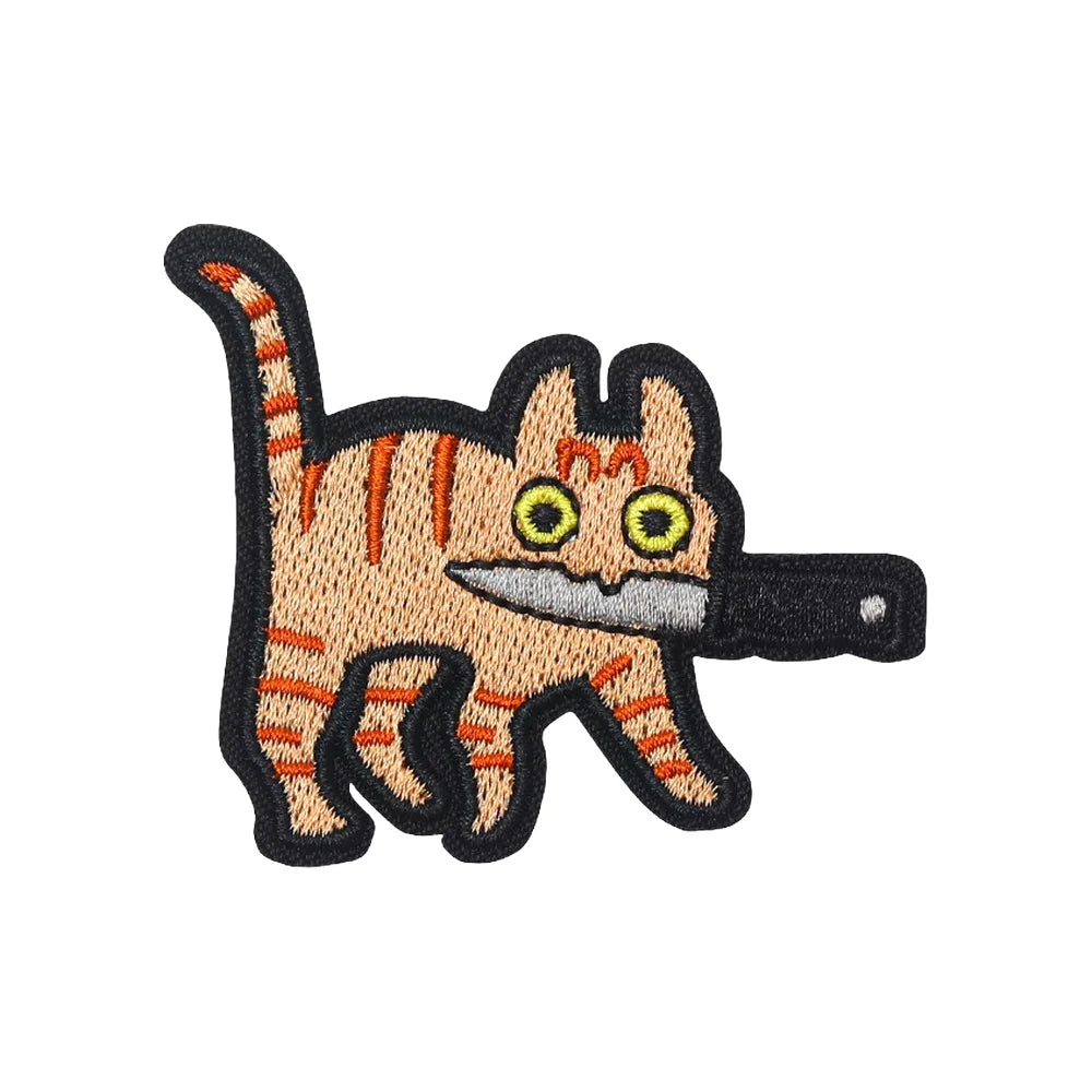 Embroidered tactical patch of a cat with orange stripes and yellow eyes