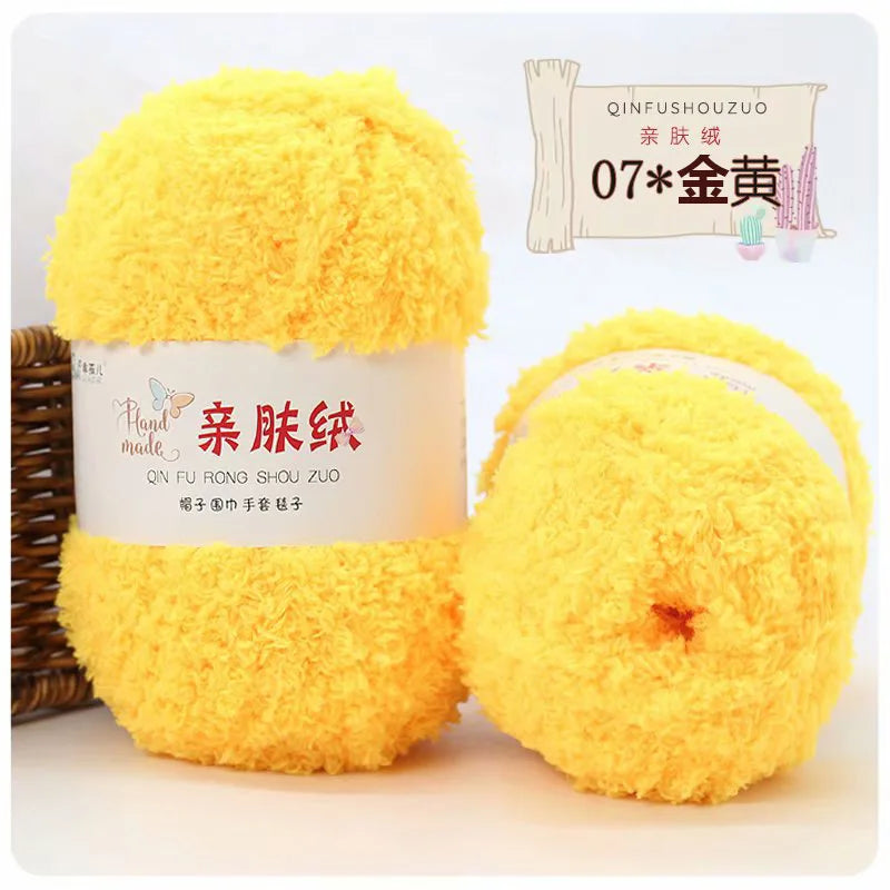 A yellow ball of soft coral velvet yarn labeled QINFUSHOUZUO 07金黃 for crafting.