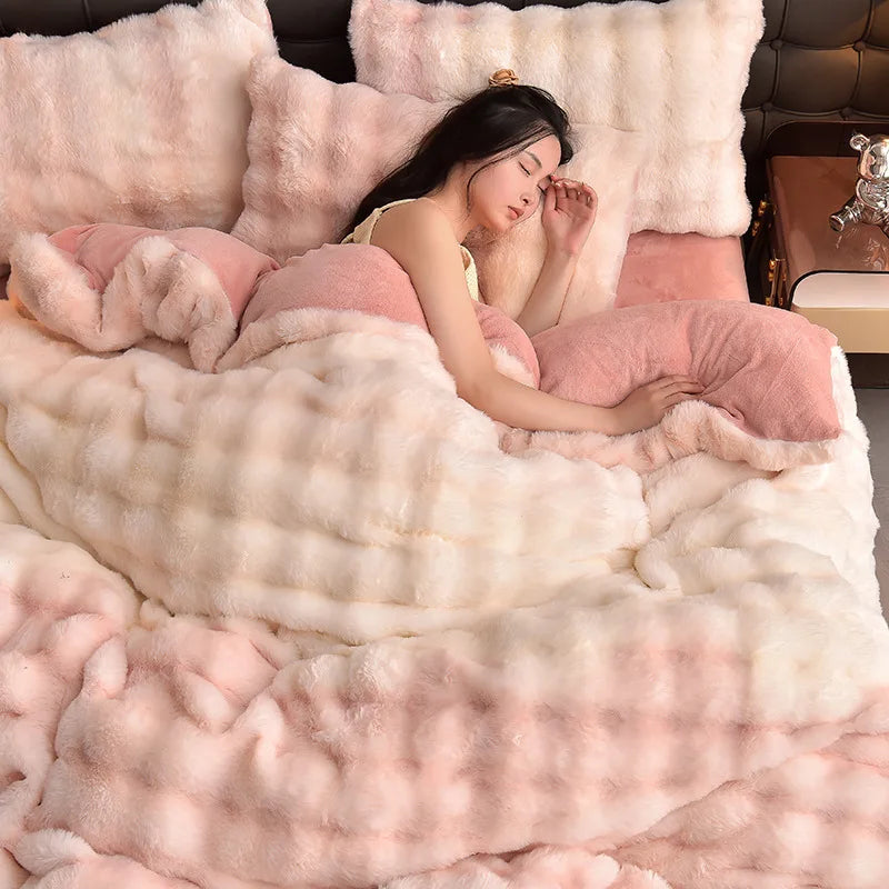 A woman is relaxing on a pink plush rabbit hair bedding set with matching pillows.