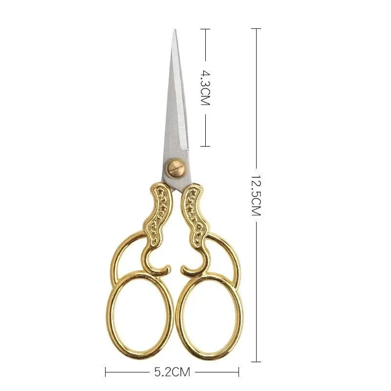 Vintage stainless steel sewing scissors with gold accents and a blade length of 4.3cm