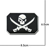 A black and white embroidery patch featuring a skull crossed by two swords.