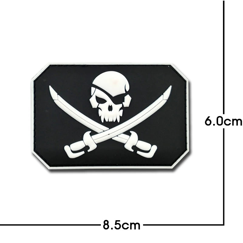A black and white embroidery patch featuring a skull crossed by two swords.