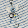 Silver and blue heart-shaped keychain featuring an adjustable clock and a white feather design