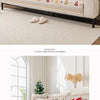 A beige sofa seat covered with a floral and geometric patterned fabric featuring red accents and white trim.