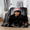A black flannel throw blanket featuring a distressed graphic design and red text on a white background.