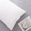 White microfiber pillow covers displayed on a gray fabric background.