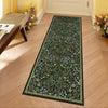 A long runner rug featuring a dense botanical pattern in shades of green, pink, and white on a light wood floor.